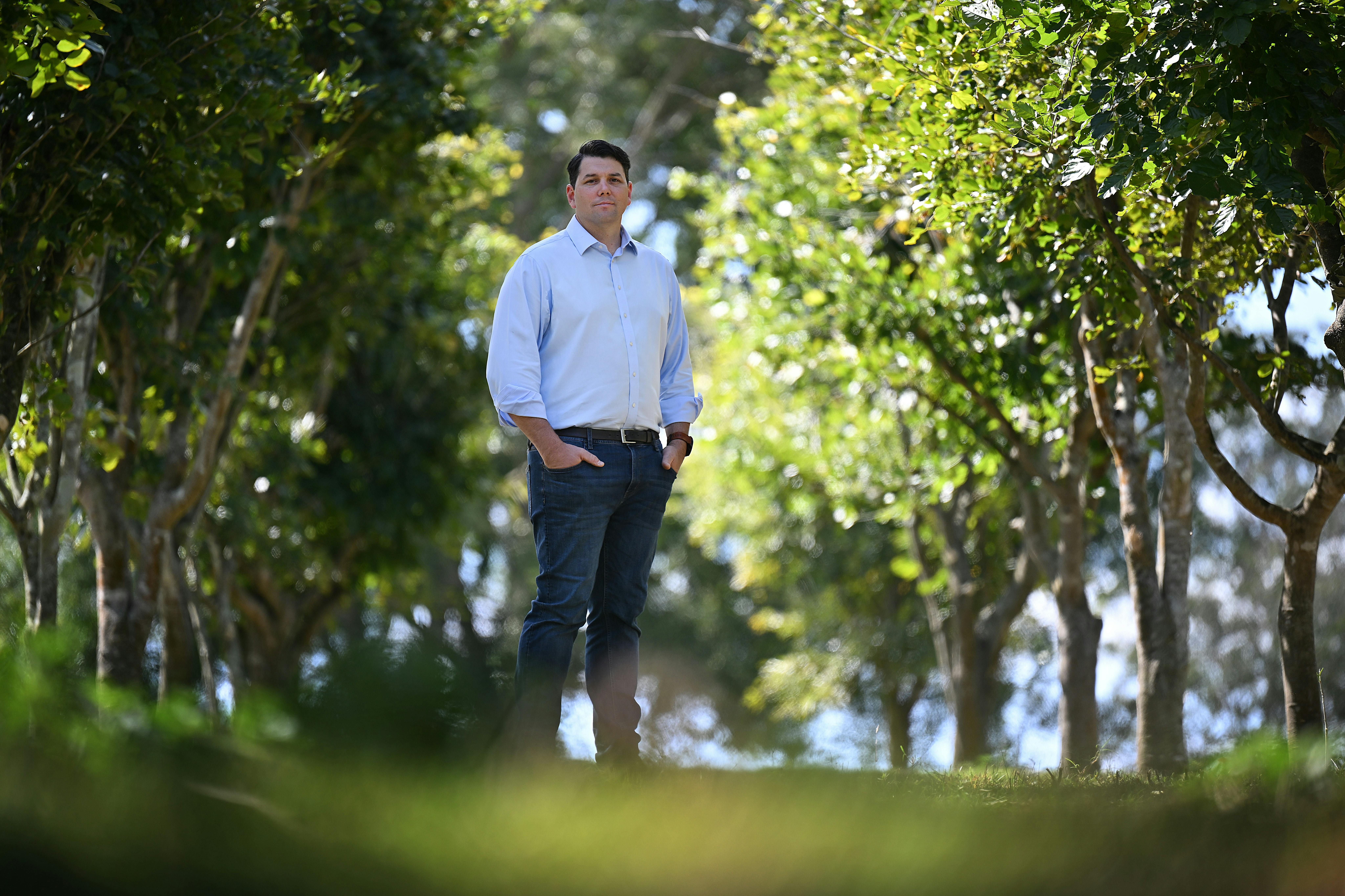 Jonathon McCarthy, chief decarbonization officer at Rio Tinto, standing among pongamia trees. Image credit Rio Tinto