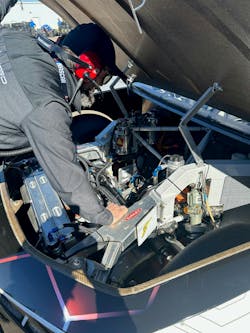 A crew member examines under the hood of the NASCAR EV prototype after its test run on the Phoenix Speedway track. Image credit Rod Walton A crew member examines under the hood of the NASCAR EV prototype after its test run on the Phoenix Speedway track. Image credit Rod Walton
