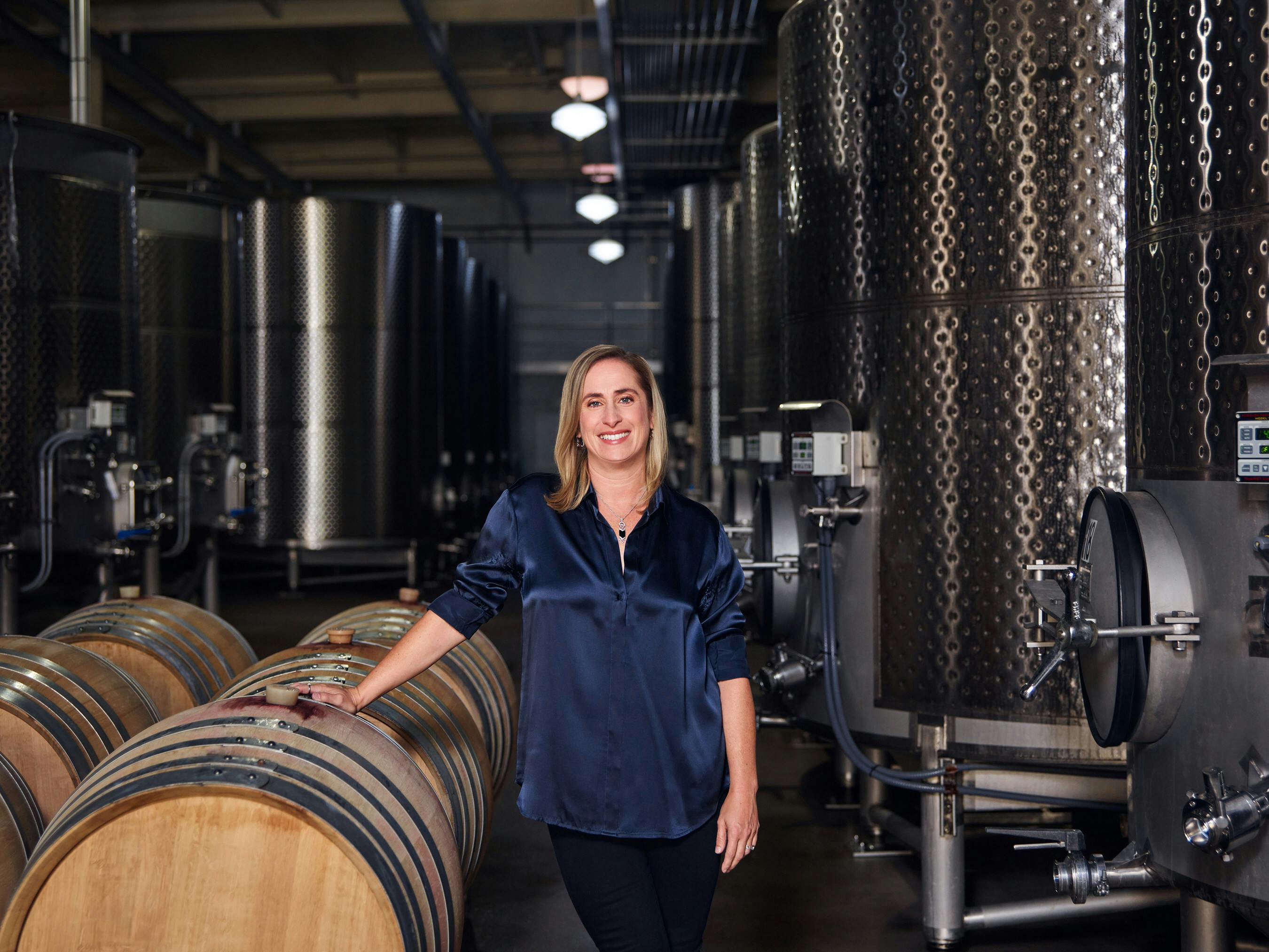 Remi Cohen, CEO of Domaine Carneros, stands in a storage area of the company's winery, which recently installed a solar and battery storage microgrid. Image credit Schneider Electric