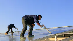 Engineering and technical personnel installing solar photovoltaic glass in Hebei, China.